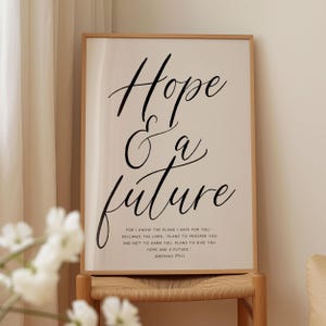 May include: A beige poster with a black calligraphy quote that reads "Hope & a future" and a smaller black text quote that reads "For I know the plans I have for you, declares the Lord, plans to prosper you and not to harm you. Plans to give you hope and a future." Jeremiah 29:11