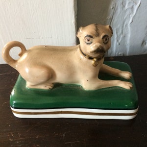 Derby Porcelain Pug Figure of a Reclining Dog, England, early 19th century Derby figurine