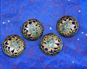 May include: Four round, brass, decorative buttons with a floral design. The buttons are green, gold, and pink with a cut-out design.