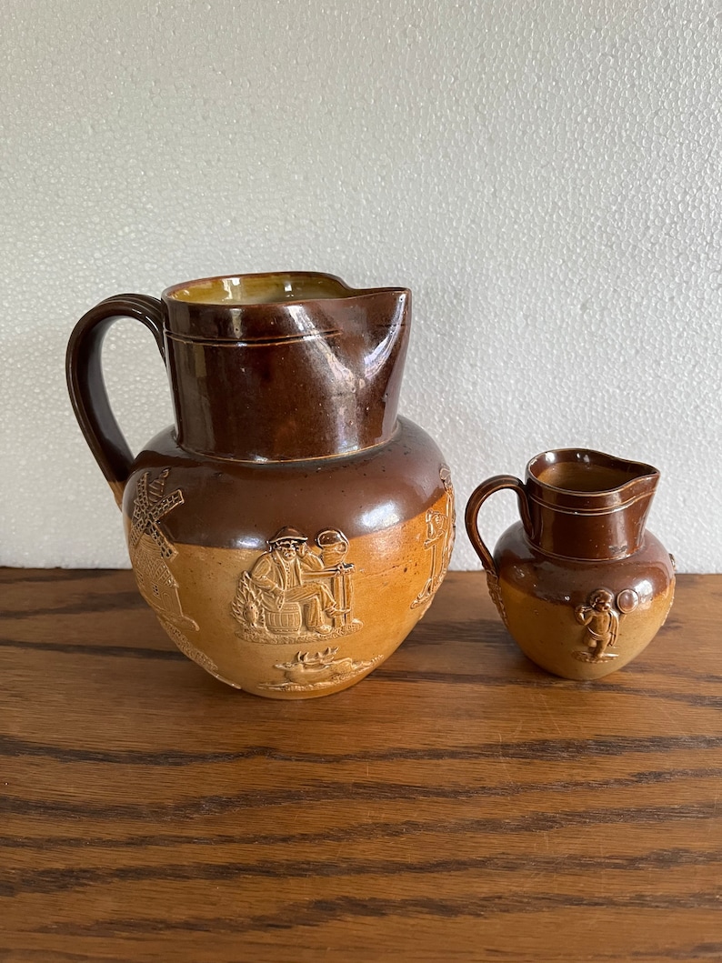 2 Antique Doulton Lambeth stoneware jugs hunt scene jug and putti jug shops