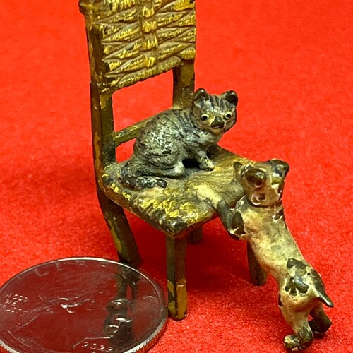 Miniature Vienna bronze Cat on chair playing with shops terrier dog