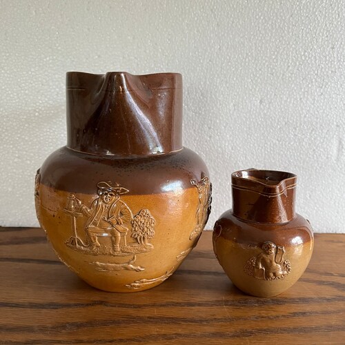 2 Antique Doulton Lambeth stoneware jugs hunt scene jug and putti jug shops