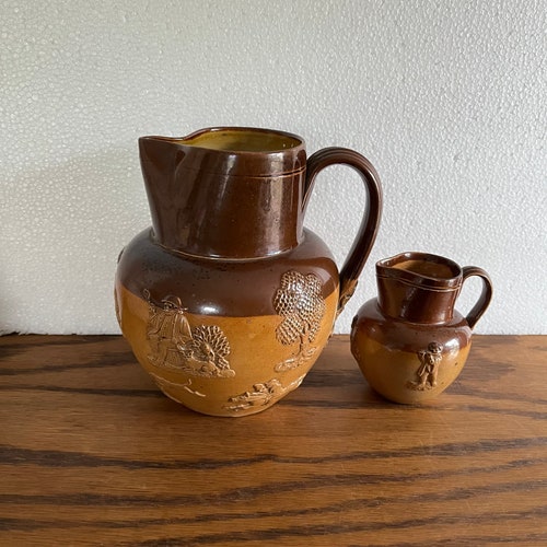 2 Antique Doulton Lambeth stoneware jugs hunt scene jug and putti jug shops