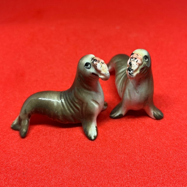 Matched pair of bone china elephant seal figurines