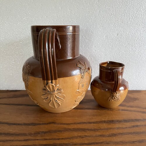 2 Antique Doulton Lambeth stoneware jugs hunt scene jug and putti jug shops