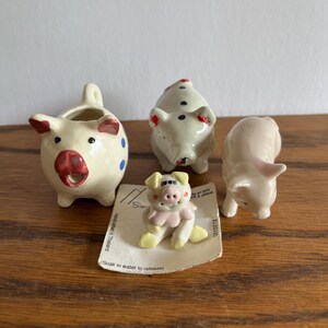 Collection of four different ceramic pigs