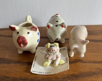 Collection of four different ceramic pigs