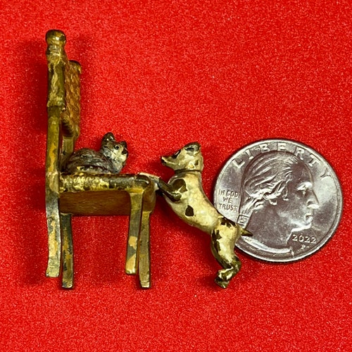 Miniature Vienna bronze Cat on chair playing with shops terrier dog