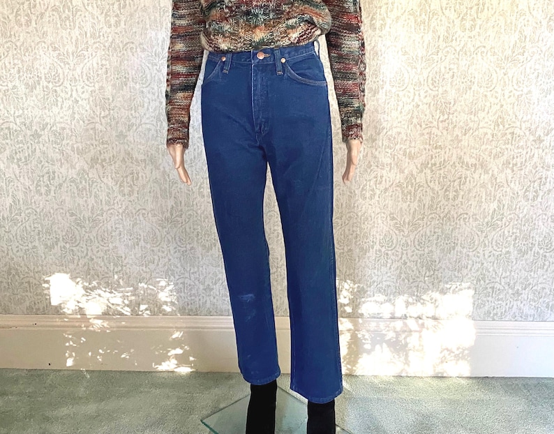 May include: A pair of blue denim jeans with a high waist and straight legs.