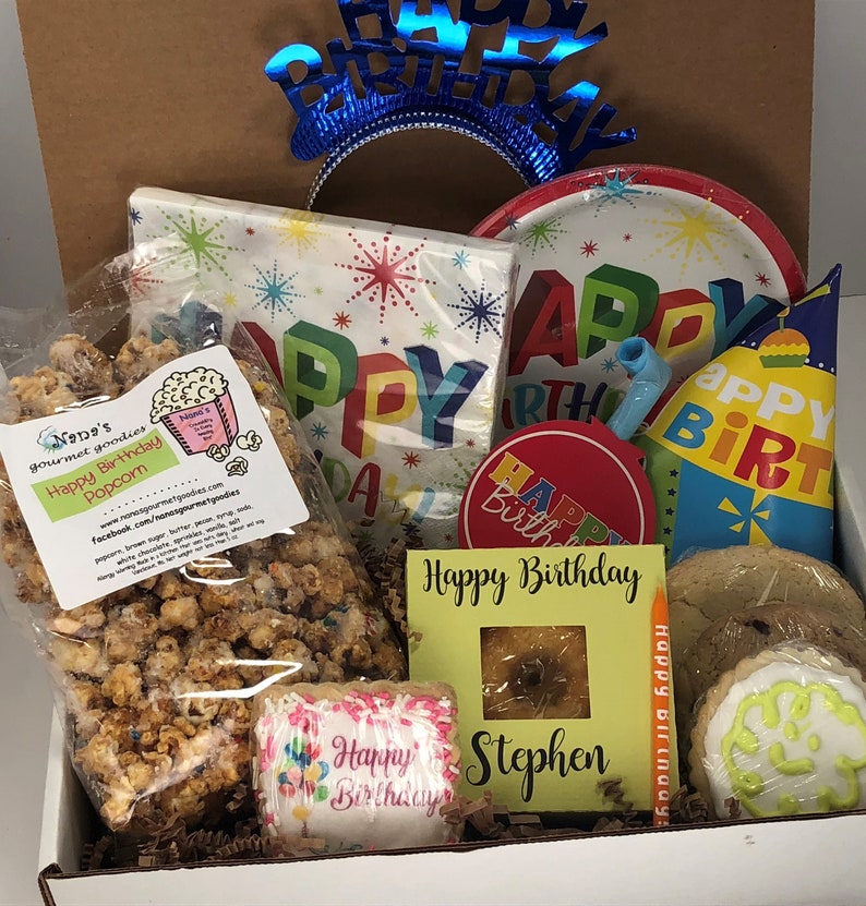 care package filled with happy birthday popcorn, party hat, party decor, and home baked goodies