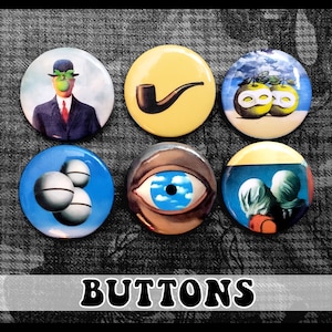 May include: Set of six round buttons featuring famous surrealist artwork by Salvador Dali. The buttons feature images of a man with an apple for a head, a pipe, two apples with eyes, a floating eye, and two figures with bags over their heads.