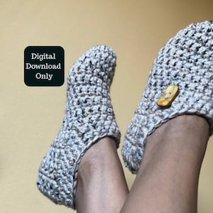 May include: Crocheted slippers in a speckled grey yarn, with a wooden button fastening. The image includes the text "Digital Download Only".