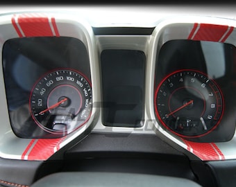 May include: Close-up of a car's dashboard with two gauges. The gauges have red and silver accents. The left gauge reads up to 160 and the right gauge reads up to 9.