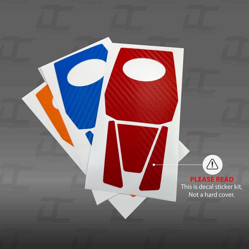 May include: Three decal sticker sheets for a car interior. The sheets are white with red, blue, and orange carbon fiber designs. The text on the bottom sheet reads "PLEASE READ This is decal sticker kit, Not a hard cover."
