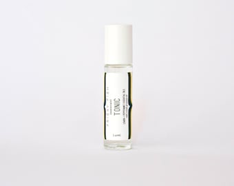 Mélange d’huiles essentielles toniques dans un rouleau pour l’aromathérapie, sur la route de citron et menthe poivrée