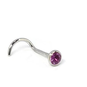 May include: A silver nose ring with a curved post and a round, bezel-set, pink gemstone. The jewelry is set against a white background. The text "Holey Noses" is written in a cursive font.
