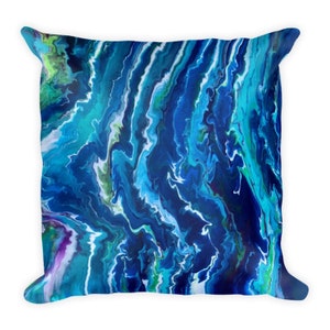 May include: A blue, green, and white abstract throw pillow with a marbled design. The pillow is square and has a soft, plush feel.