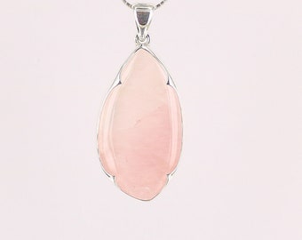 May include: A silver pendant with a light pink rose quartz gemstone. The pendant is shaped like a teardrop and has a delicate, scalloped edge. The pendant is hanging from a silver chain.