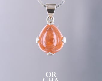 May include: A silver necklace with a teardrop-shaped pendant. The pendant features a polished, orange-colored gemstone with silver accents. The text "OR CHA JEWELRY" is at the bottom of the image.