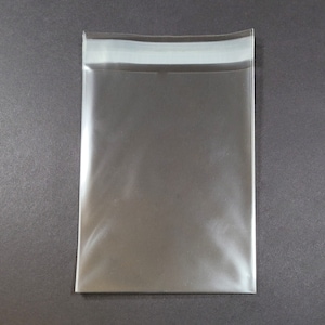 May include: A clear plastic bag with a white adhesive strip across the top.