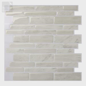 May include: A rectangular wall tile sheet featuring a staggered brick pattern with a glossy, light gray and white faux marble finish. The individual tiles are arranged in horizontal rows with thin white grout lines, branded with the text tic tac tiles.