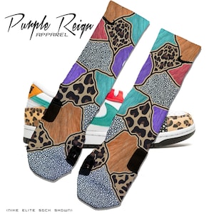 May include: A pair of colorful socks with a patchwork design featuring leopard print, fur, and polka dots. The socks are shown with a pair of sneakers with a similar patchwork design. The text "Purple Reign Apparel" is visible in the top left corner of the image.