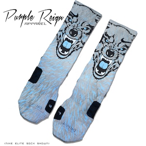 May include: A pair of grey and blue athletic socks with a wolf graphic. The socks have the text "DRI-FIT" on the bottom and "Purple Reign Apparel" at the top.