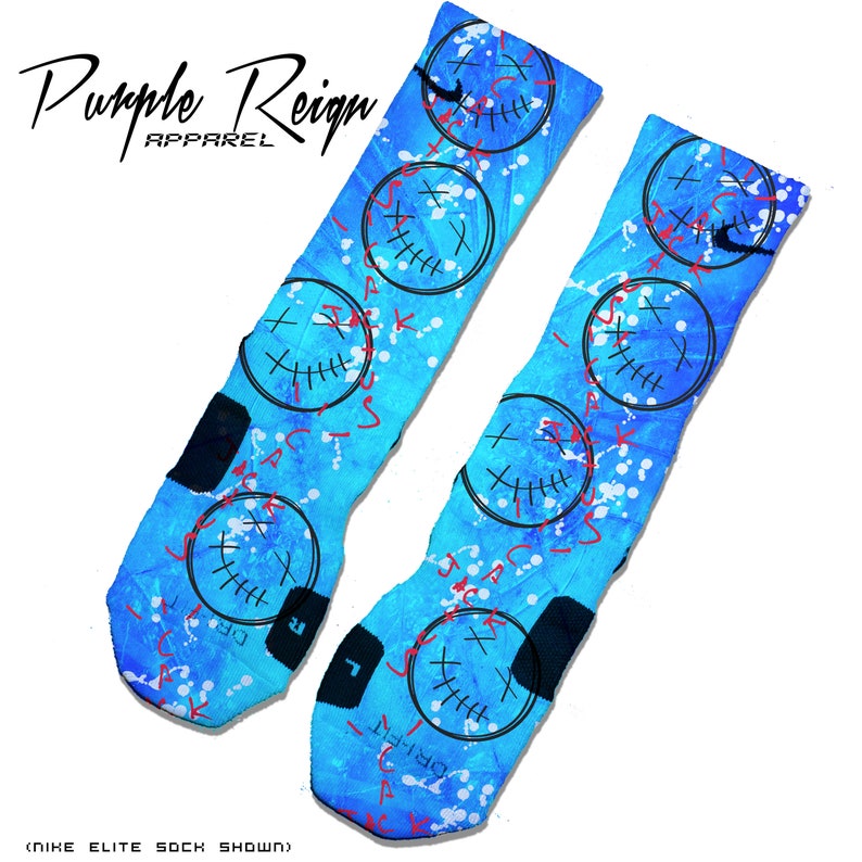 May include: A pair of blue and white basketball socks with a graphic print of a stitched smiley face with an 'X' over the eyes. The socks have a black and white Nike logo on the side.