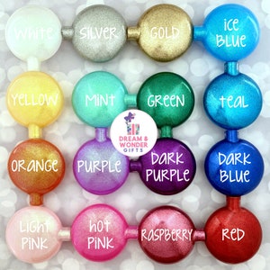 May include: A collection of 16 round, glitter-covered bottle stoppers in various colors, including white, silver, gold, ice blue, yellow, mint, green, teal, orange, purple, dark purple, dark blue, light pink, hot pink, raspberry, and red.