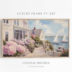 May include: A framed painting depicts a coastal scene with a house, American flag, and sailboats. The house has a porch and is surrounded by pink flowers. The sky is blue with clouds. The text "LUXURY FRAME TV ART" and "CHATEAU MICHELE" are visible.