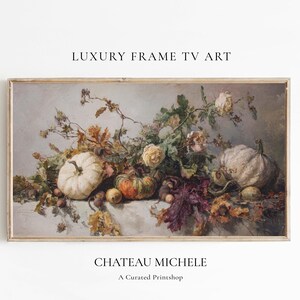 May include: A framed still life painting featuring pumpkins, gourds, and roses. The artwork has a neutral color palette with muted tones of white, green, orange, and brown. The text "LUXURY FRAME TV ART" and "CHATEAU MICHELE" are visible.