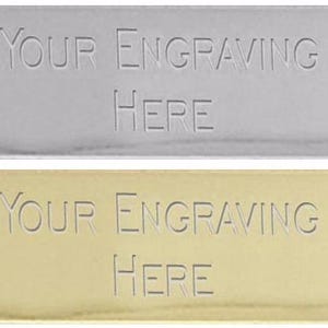 May include: Two rectangular metal plates, one silver and one gold, with the text "YOUR ENGRAVING HERE" engraved on each.