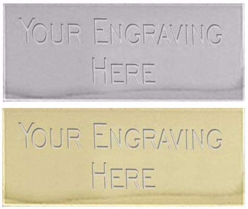 May include: Two rectangular metal plates, one silver and one gold, with the text "YOUR ENGRAVING HERE" engraved on each.