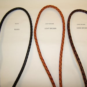 May include: Three leather cords in black, light brown, and dark brown. The cords are braided and are approximately 1/2 inch wide.