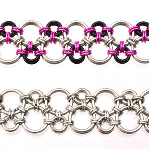 May include: Two chainmail bracelets, one with black and pink rings, the other with silver rings.