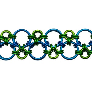 May include: A silver chain bracelet with alternating blue and green metal rings. The bracelet has a silver clasp with a hammered texture.