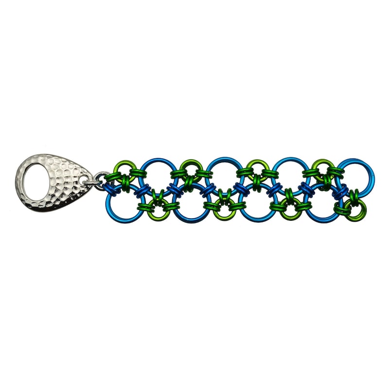 May include: A silver chain bracelet with alternating blue and green metal rings. The bracelet has a silver clasp with a hammered texture.