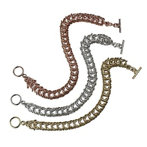 May include: Three chain bracelets in different colors: gold, silver, and rose gold. Each bracelet has a unique design with interlocking links.
