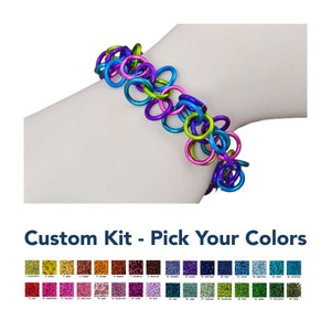 May include: Customizable bracelet kit with a variety of colors to choose from. The bracelet is made of metal rings in shades of blue, green, and pink.  The image shows a sample bracelet made with these colors.