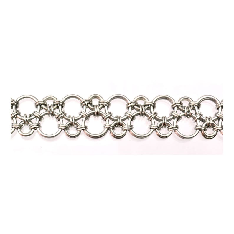 May include: A silver chainmail bracelet with a repeating pattern of interlocking rings.