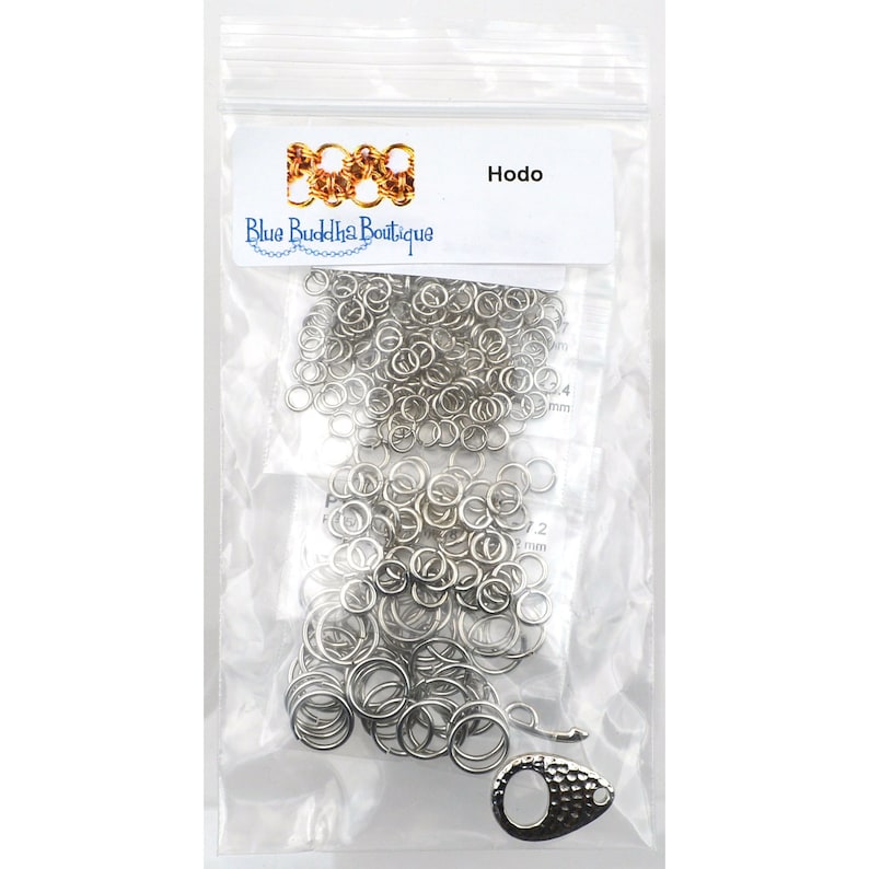 May include: A clear plastic bag containing a large quantity of silver jump rings, a silver lobster clasp, and a small white label with the text "Hodo" and "Blue Buddha Boutique".