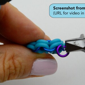 May include: Close-up of a hand holding a turquoise and blue rubber band bracelet being closed with pliers. The bracelet is being closed with a purple jump ring.