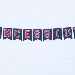 May include: A navy blue banner with red letters spelling "CONCESSIONS" and baseball-themed decorations. The banner is strung on a white wall.