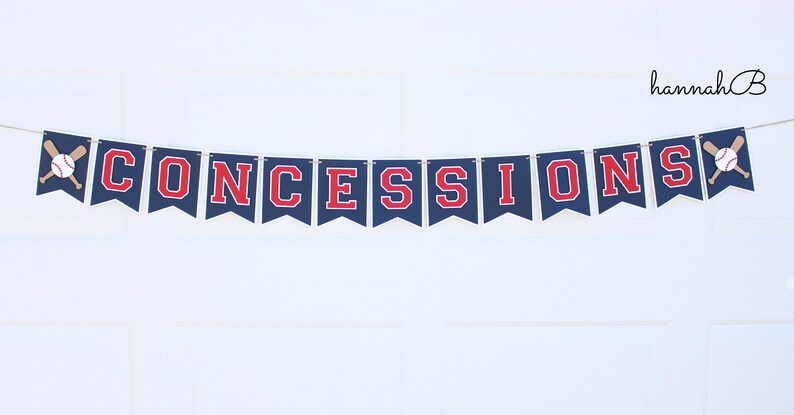 May include: A navy blue banner with red letters spelling "CONCESSIONS" and baseball-themed decorations. The banner is strung on a white wall.