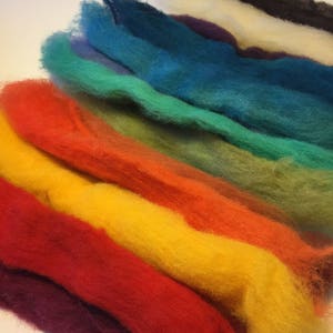 May include: A rainbow assortment of wool roving in various colors, including black, white, purple, teal, green, yellow, orange, red, and burgundy.