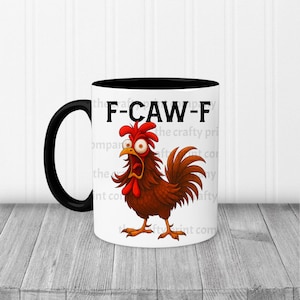 May include: A white ceramic mug with a black handle and rim. The mug features a cartoon rooster with an open beak and the text "F-CAW-F". The rooster is brown, red, and orange.