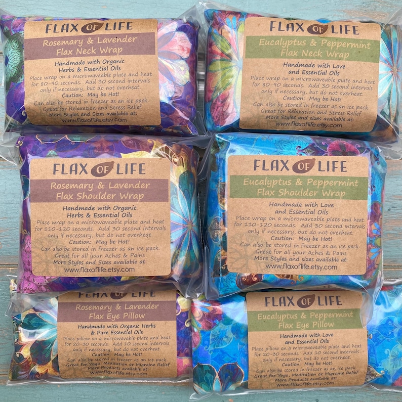 May include: Six colorful flax heat packs with labels that read "Flax of Life" and include the scents and types of packs: Rosemary & Lavender Flax Neck Wrap, Eucalyptus & Peppermint Flax Neck Wrap, Rosemary & Lavender Flax Shoulder Wrap, Eucalyptus & Peppermint Flax Shoulder Wrap, Rosemary & Lavender Flax Eye Pillow, Eucalyptus & Peppermint Flax Eye Pillow.  The packs are made with organic herbs and essential oils.