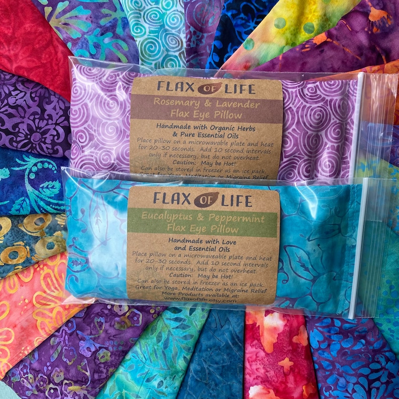 May include: Two flax eye pillows in individual clear plastic bags. The top bag is purple with a label that reads "FLAX OF LIFE Rosemary & Lavender Flax Eye Pillow Handmade with Organic Herbs & Pure Essential Oils Place pillow on a microwavable plate and heat for 20-30 seconds. Add 10 second intervals only if necessary, but do not overheat. Caution: May be Hot! Can also be stored in freezer as an ice pack. Great for Yoga, Meditation or Migraine Relief. www.flaxonlife.etsy.com". The bottom bag is blue with a label that reads "FLAX OF LIFE Eucalyptus & Peppermint Flax Eye Pillow Handmade with Love and Essential Oils Place pillow on a microwaveable plate and heat for 20-30 seconds. Add 10 second intervals only if necessary, but do not overheat. Caution: May be Hot! Can also be stored in freezer as an ice pack. Great for Yoga, Meditation or Migraine Relief. More Products available at www.flaxonlife.etsy.com".