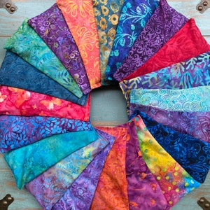 May include: A collection of colorful fabric squares with various patterns, arranged in a circle. The fabric squares are made of cotton and have a variety of colors, including blue, red, green, and purple. The fabric squares are all different sizes and shapes, and they are all sewn together to create a unique and eye-catching design.