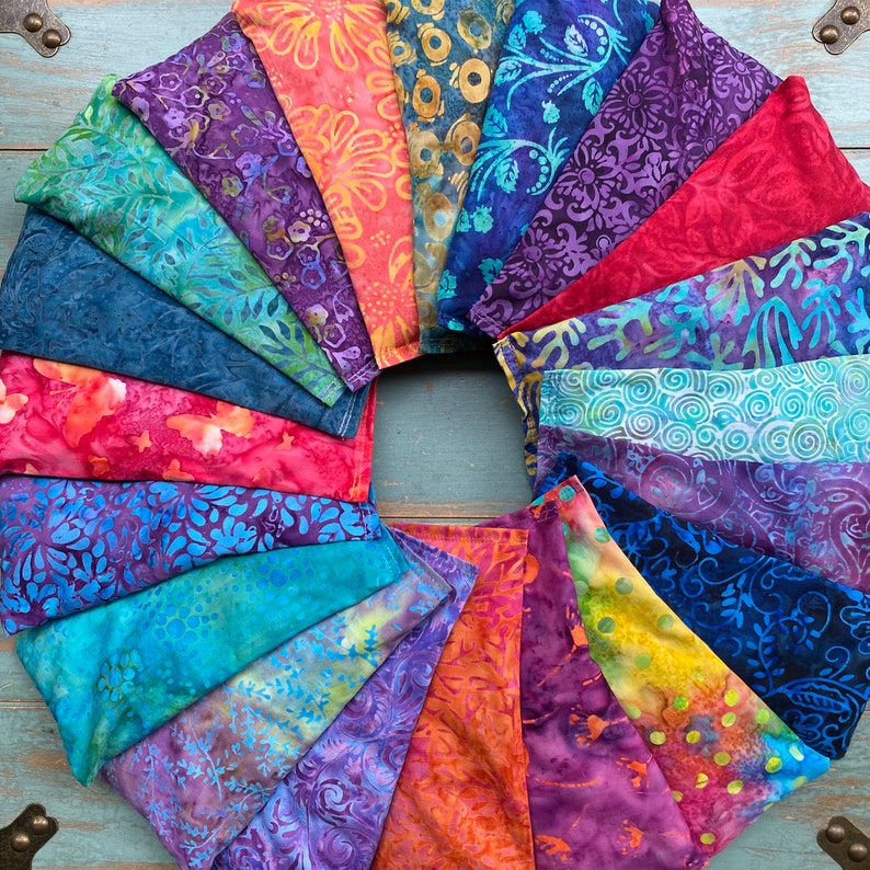 May include: A collection of colorful fabric squares with various patterns, arranged in a circle. The fabric squares are made of cotton and have a variety of colors, including blue, red, green, and purple. The fabric squares are all different sizes and shapes, and they are all sewn together to create a unique and eye-catching design.